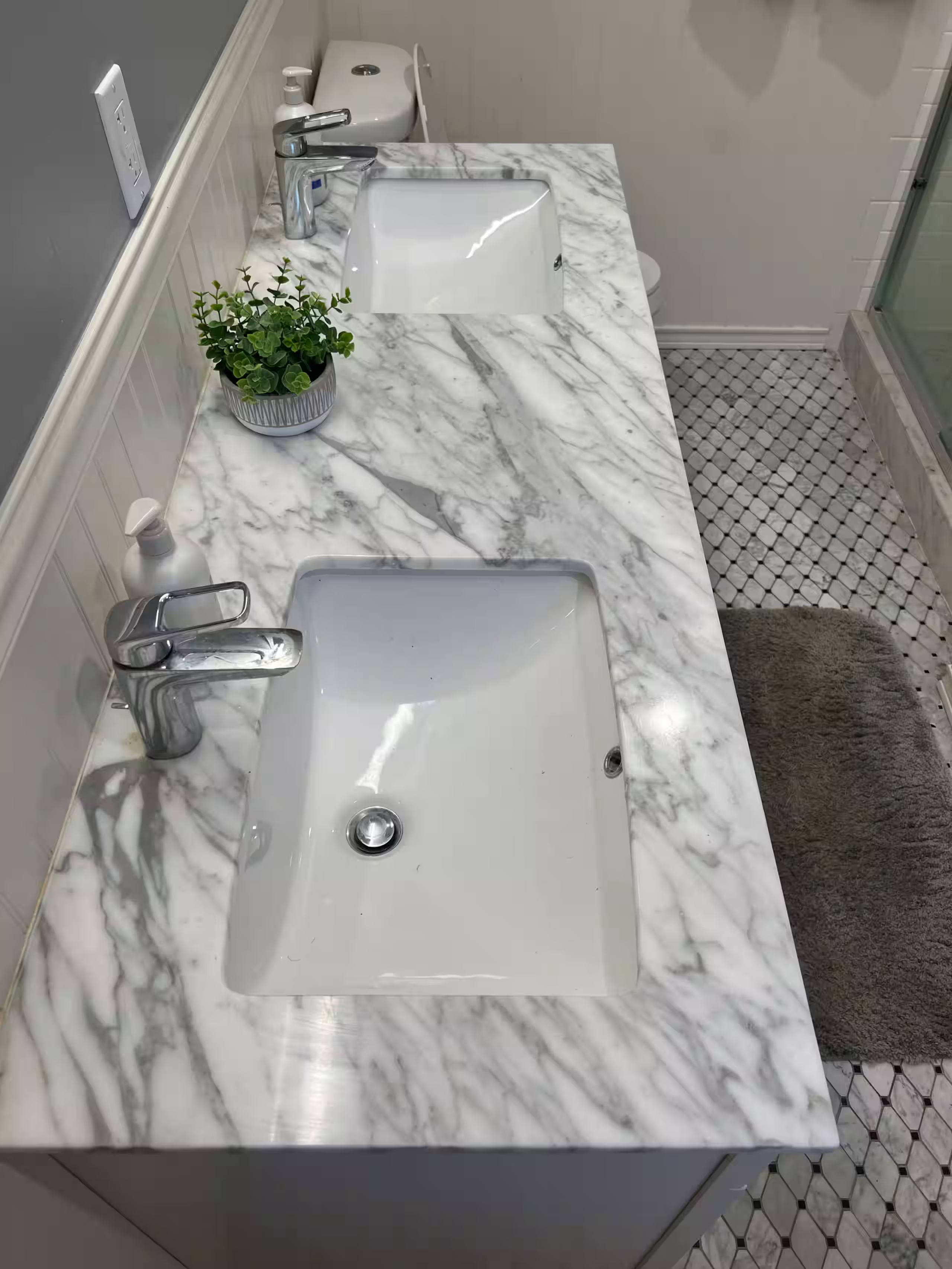 En-suite bathroom with a double marble vanity and tile floor