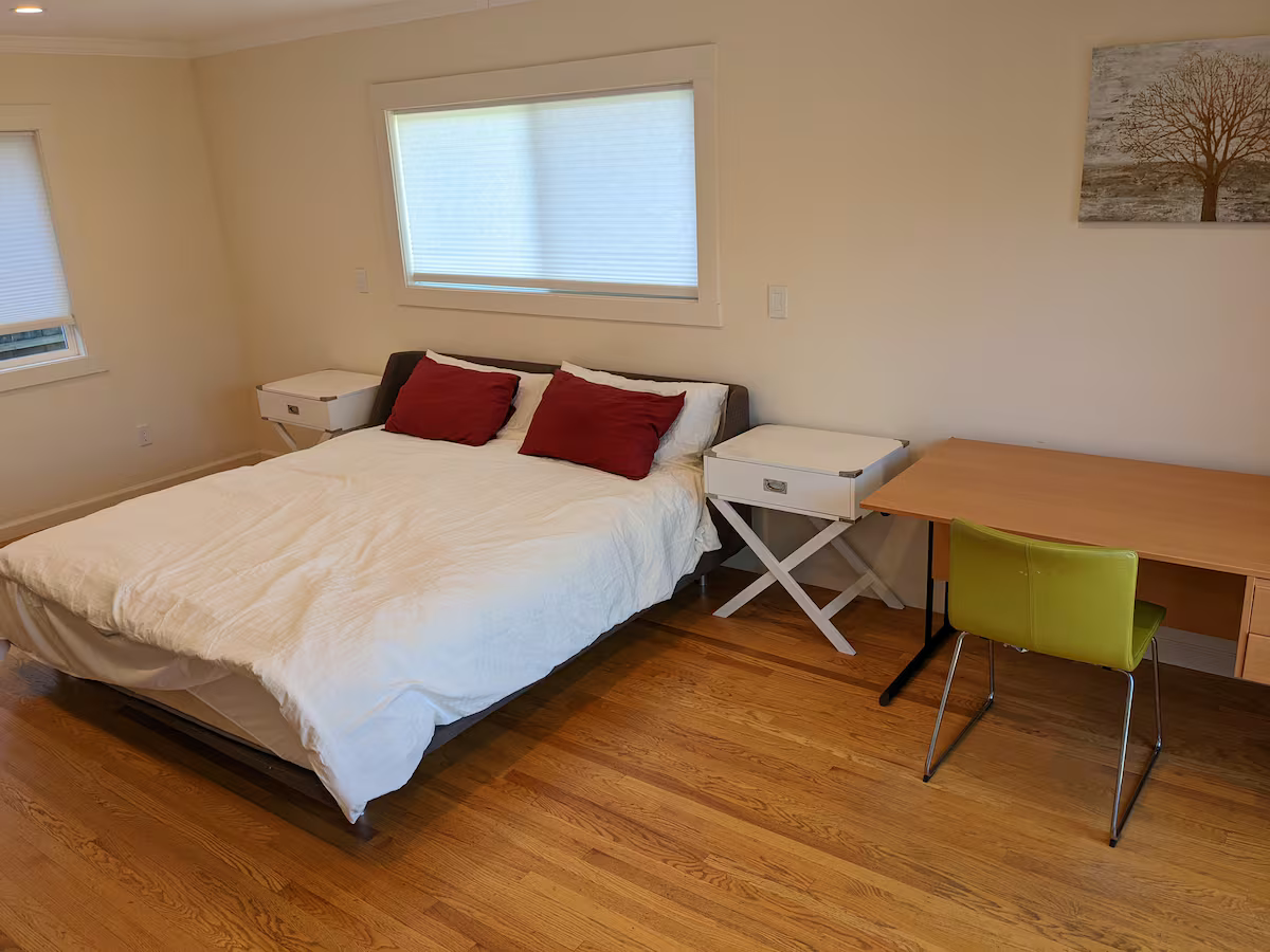 Master bedroom with a king bed, nightstands, and a work desk